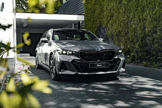 bmw-i5-touring-grijs-voorkant-huis-oprit-ekris